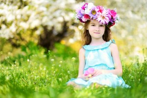 Adorable little girl in blooming cherry garden