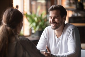 Rear,View,Woman,Sitting,At,Table,In,Cafe,With,Handsome